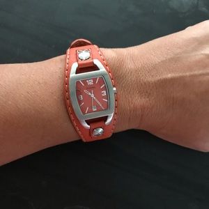 Women’s orange Fossil watch in good condition.